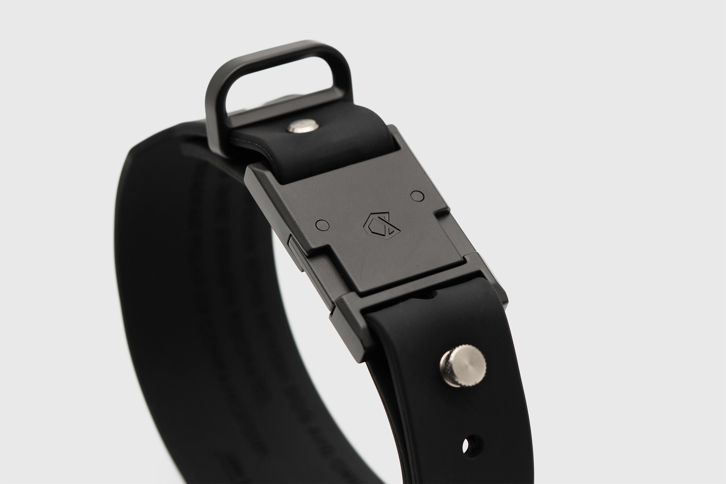 Close-up of Little Lupo Collar C1's matte black tactical buckle and D-ring, showcasing the durable LFGB silicone material and sleek design.