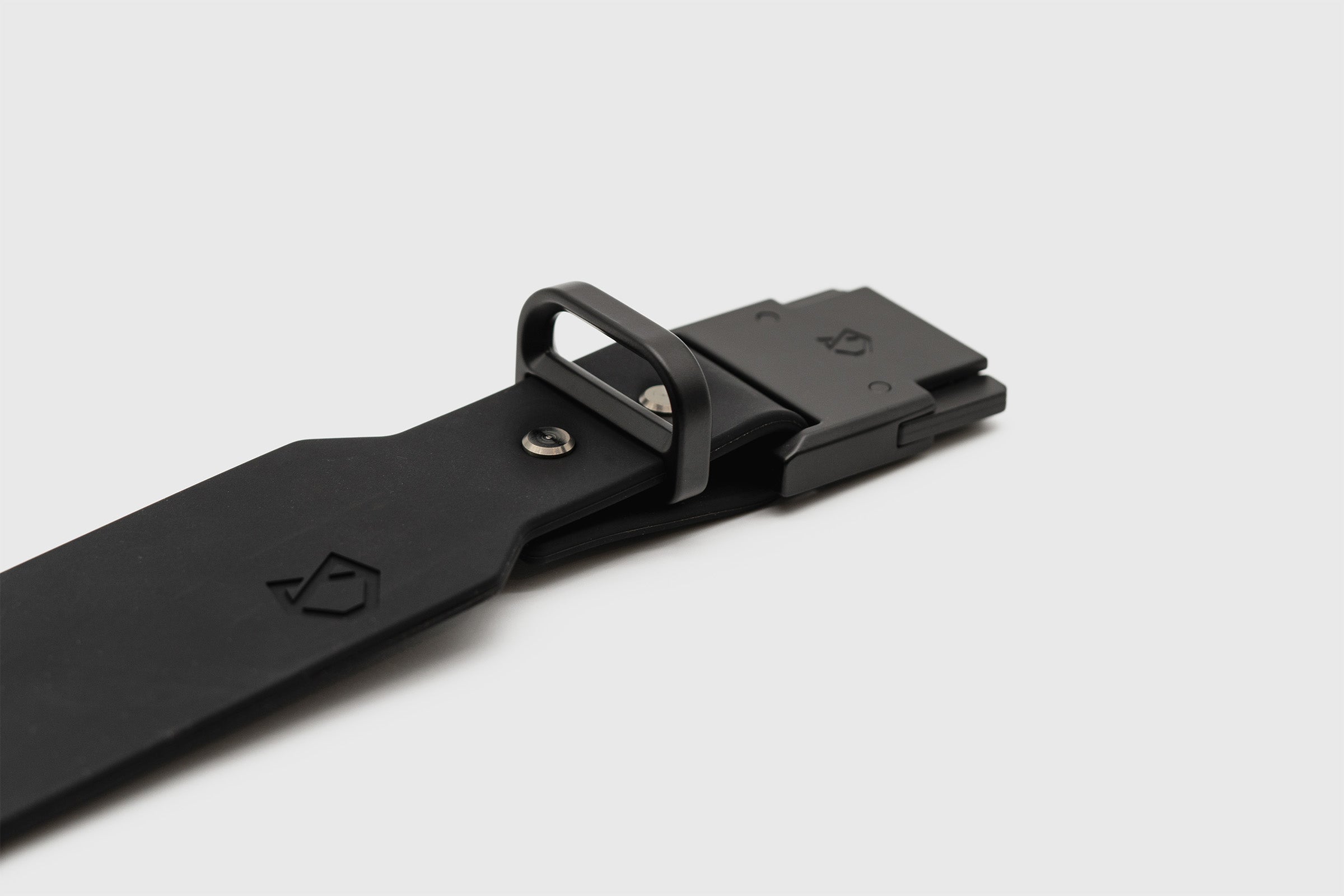 Detailed shot of the Little Lupo Collar C1, showing the sturdy black LFGB silicone band, metal D-ring, metal buckle, and the brand's debossed logo.