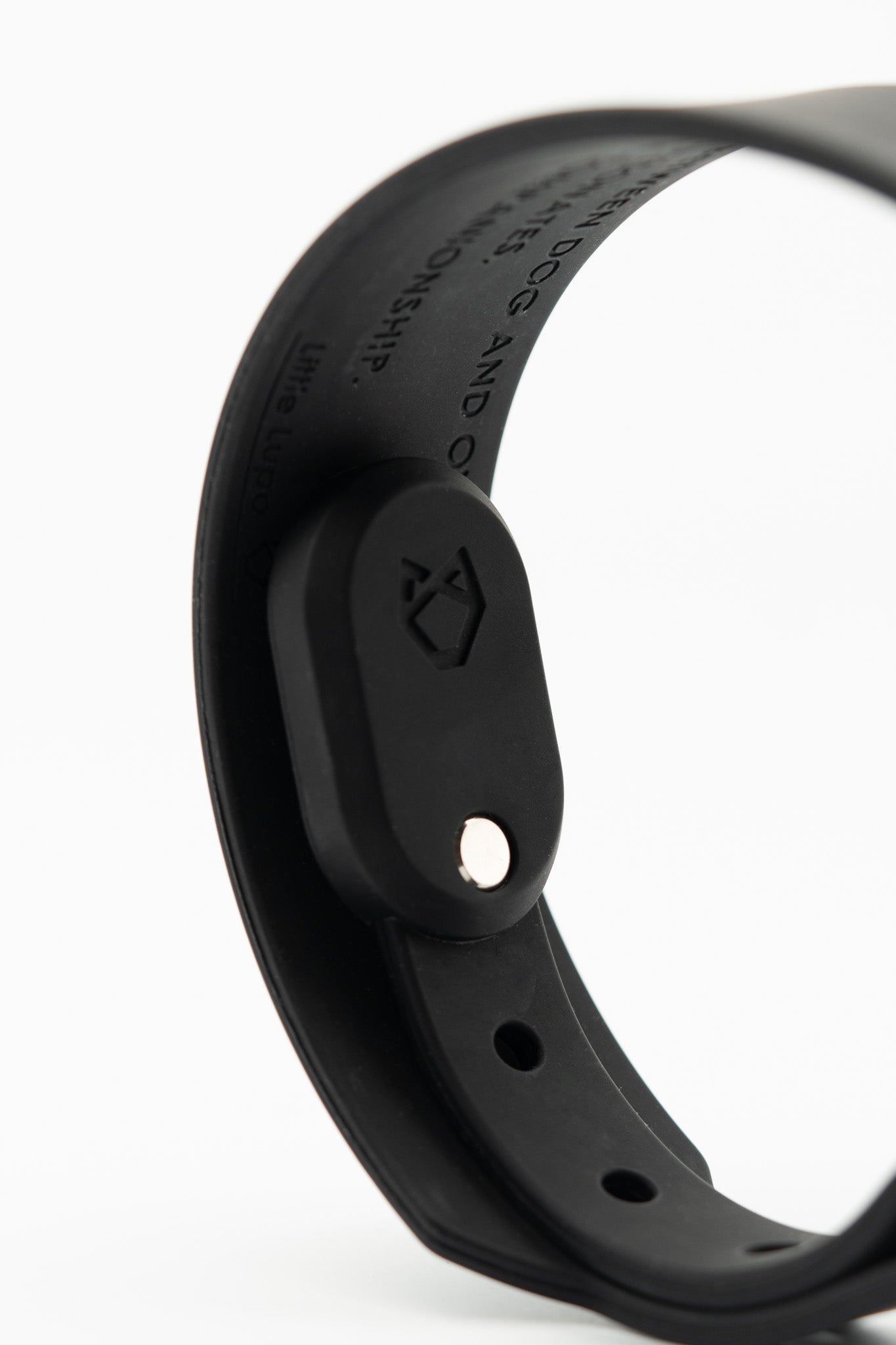 Little Lupo AirTag Holder attached to a dog collar, revealing its snug internal fit and the engraved logo.
