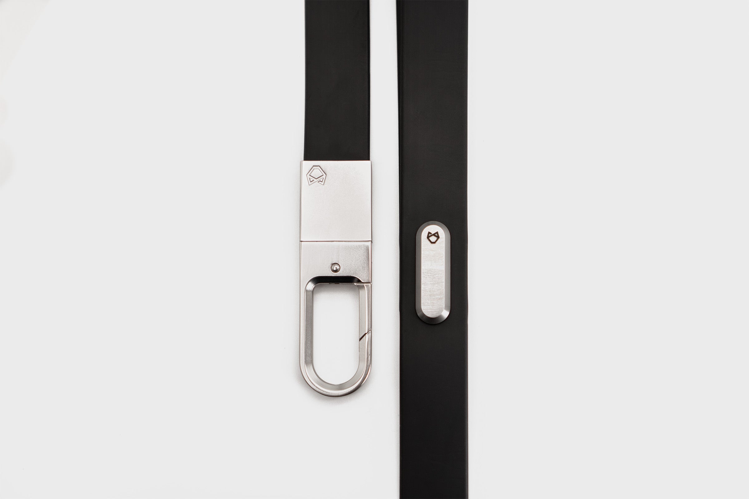 Full vertical view of the Little Lupo Leash L4, a black 54-inch dog leash featuring a sleek stainless steel connecting monument for the handle, silicone-coated tactical nylon webbing and secure stainless steel clip. 