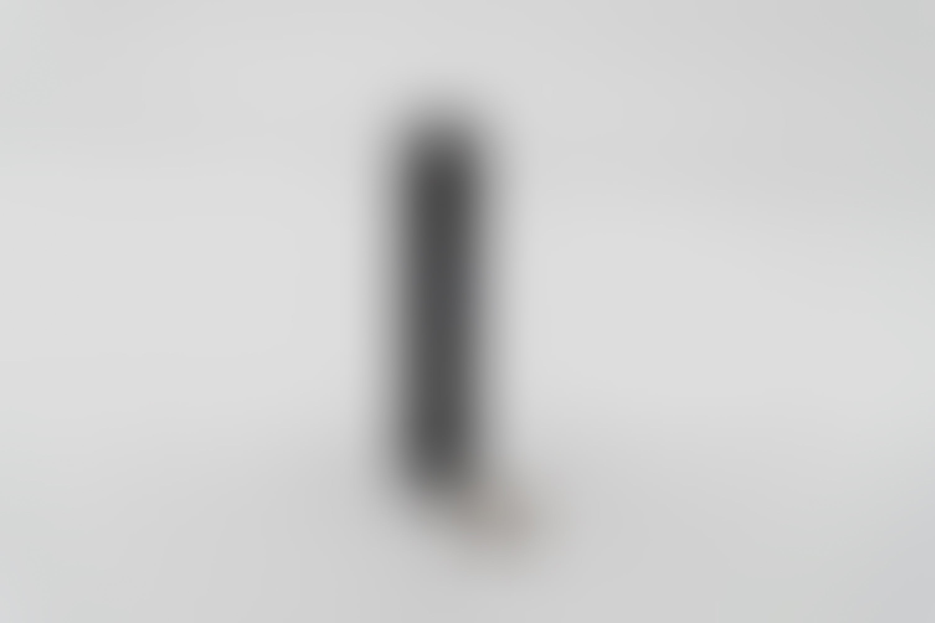 A blurred image of a black dog accessory.