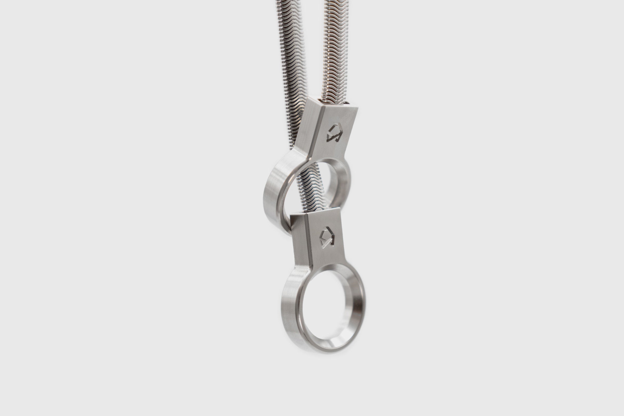 Little Lupo Subtle Strength slip collar showcasing its unique, tight bend radius and two CNC machined stainless steel rings, emphasizing minimalist design and durability.