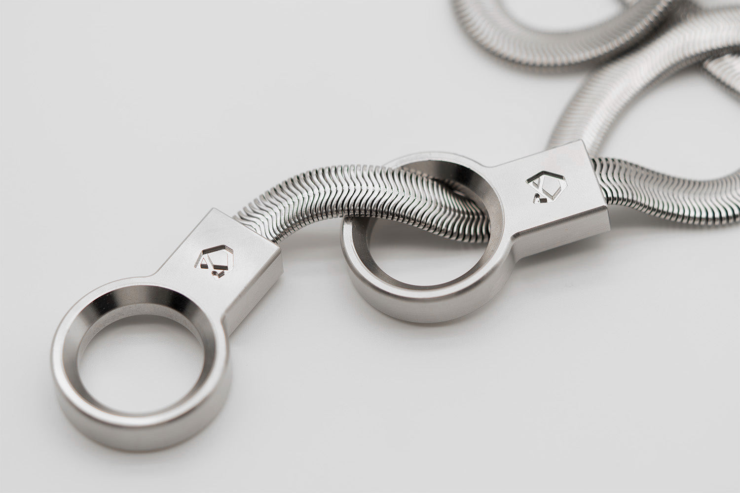 Close-up of the Little Lupo Subtle Strength Collar's mechanically engineered stainless steel links, showing the tight bend radius and fluid construction.