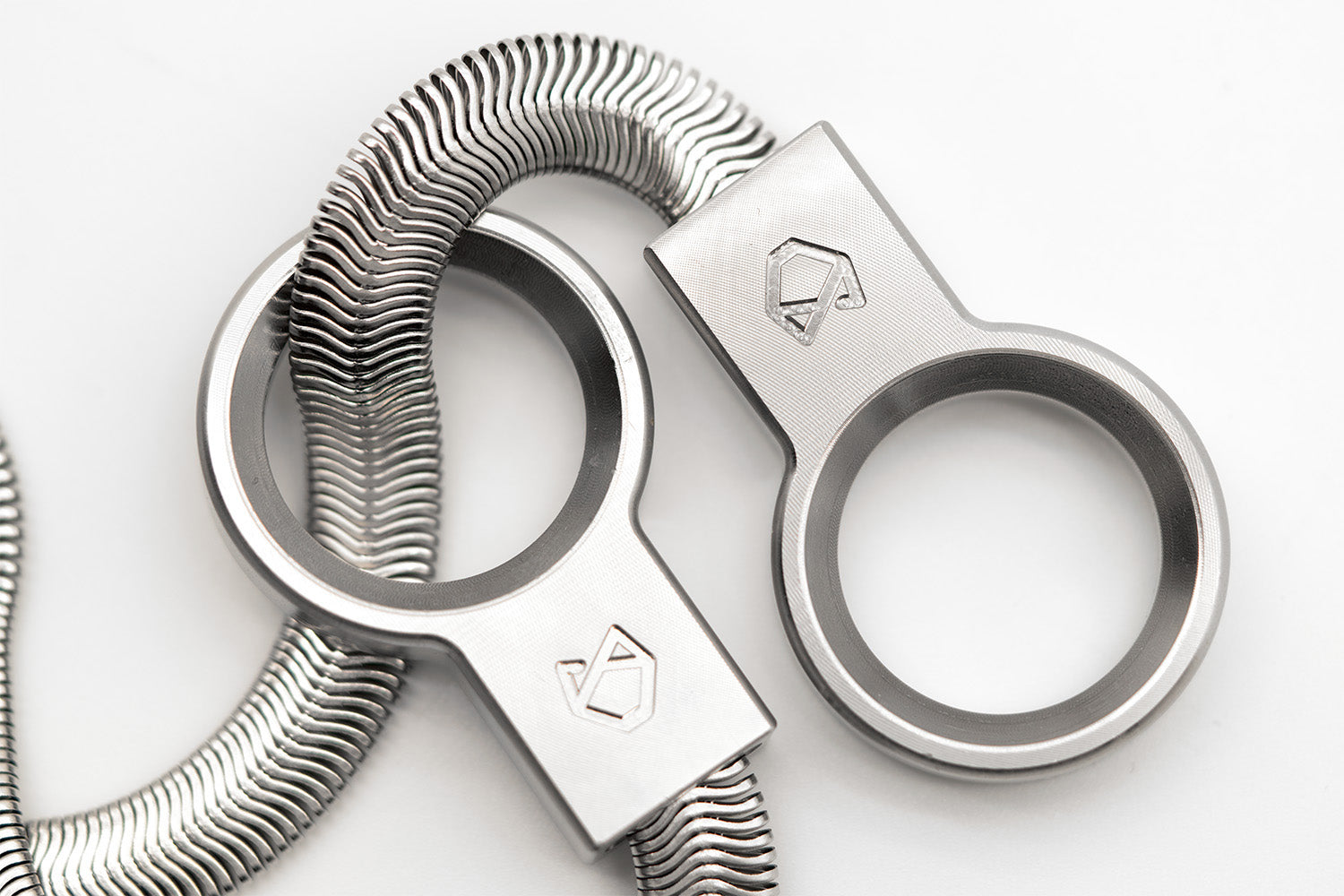 Angled close-up of the Little Lupo Subtle Strength Collar's stainless steel rings and flexible links, highlighting the corrosion-resistant material and fluid compact design.