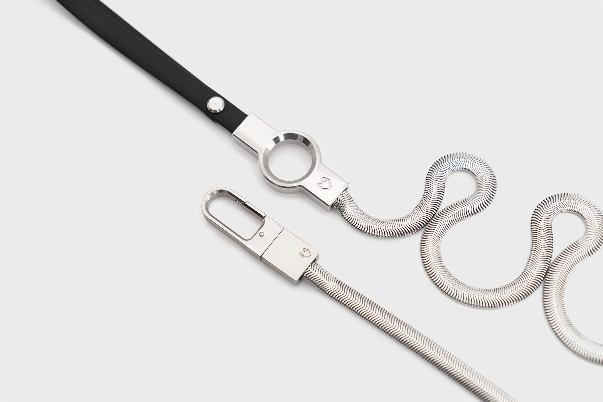 Close-up of Little Lupo Subtle Strength Leash showing the sleek stainless steel chain, durable clip, and black silicone coated handle, emphasizing its robust yet elegant design.