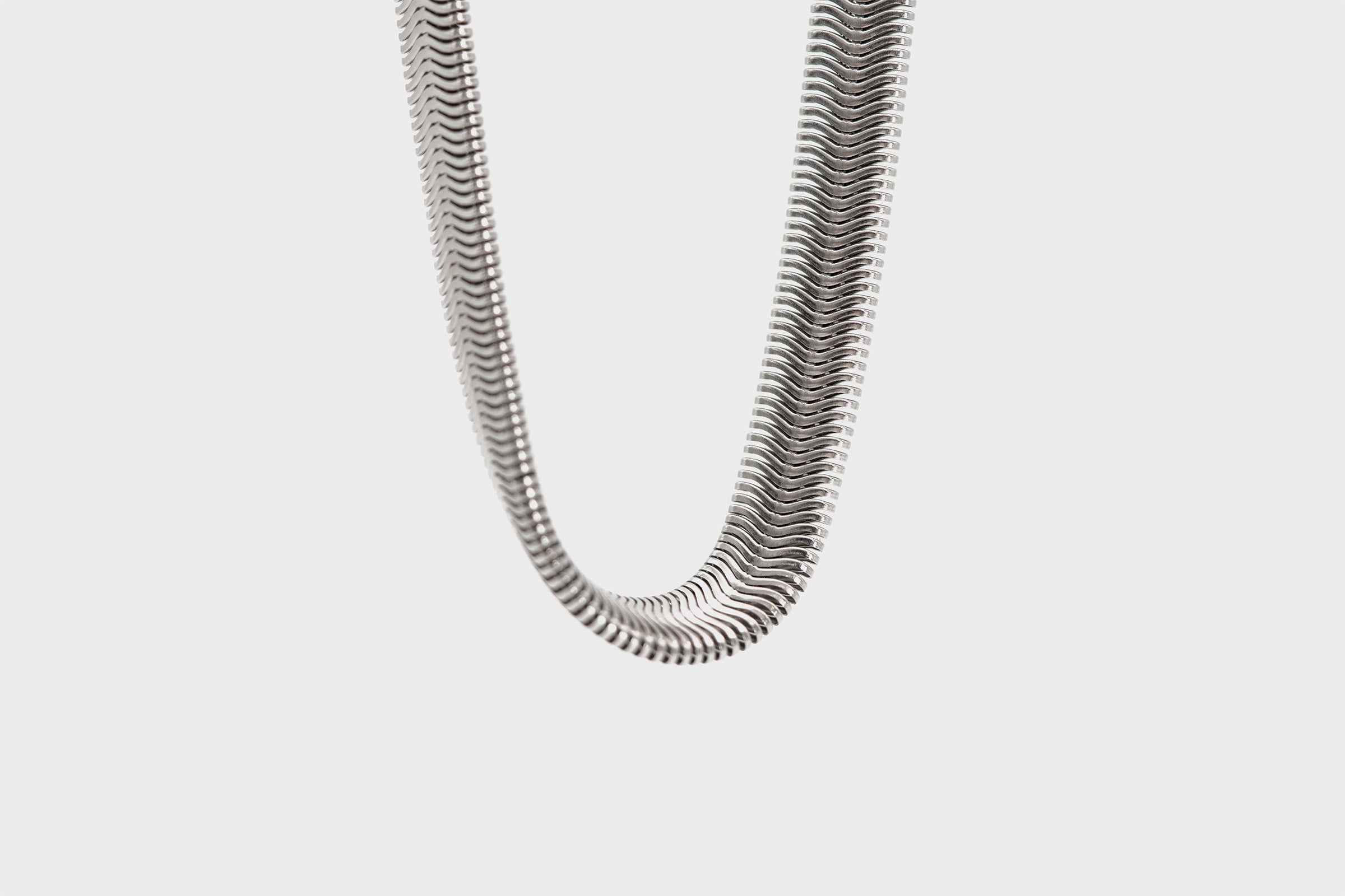 Detailed close-up of the Little Lupo Subtle Strength Leash's unique stainless steel snake chain, highlighting its fluid, durable construction and sleek texture.